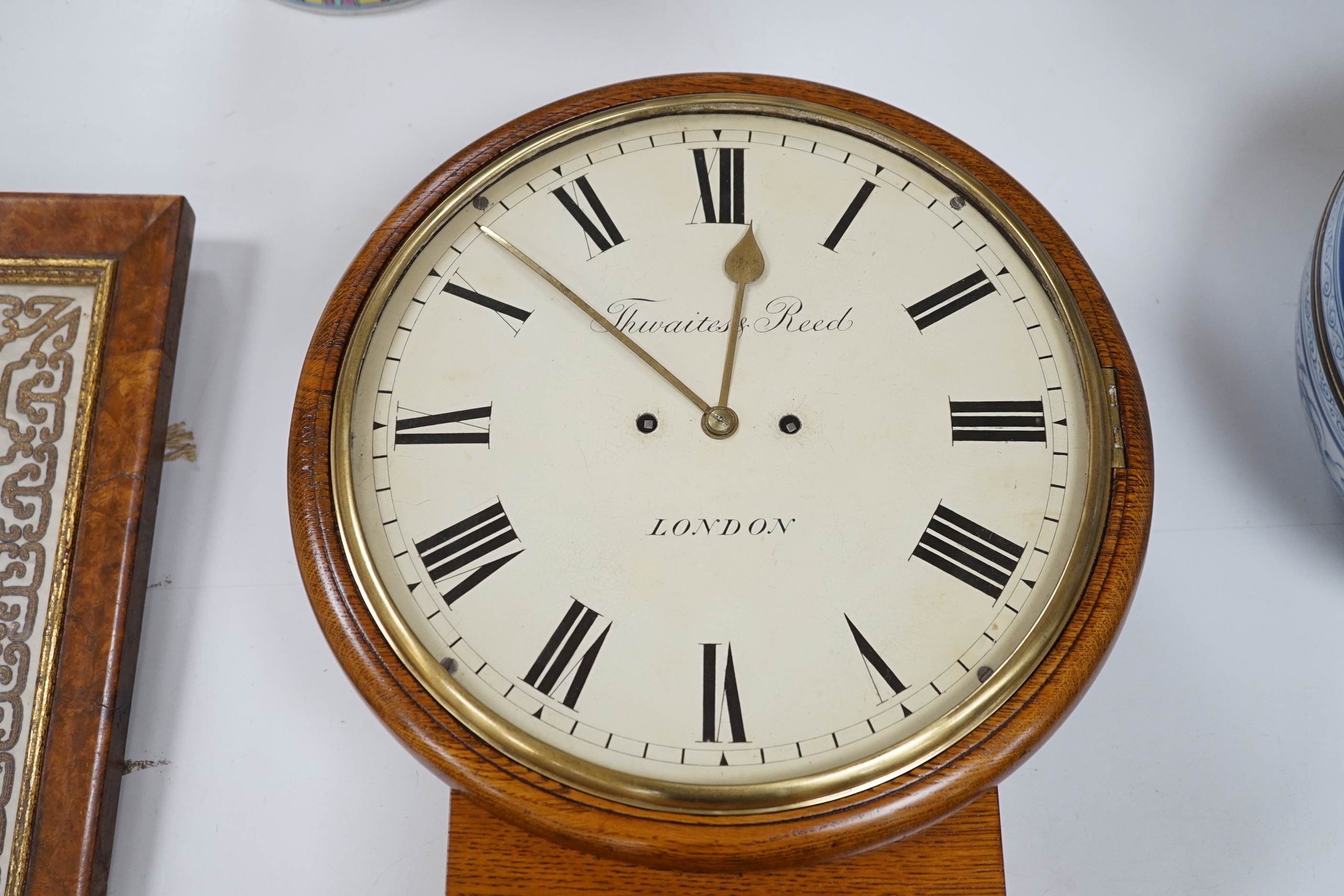 Thwaites and Reed. A Victorian oak drop dial wall clock the twin fusee movement striking on a bell, 44cm high